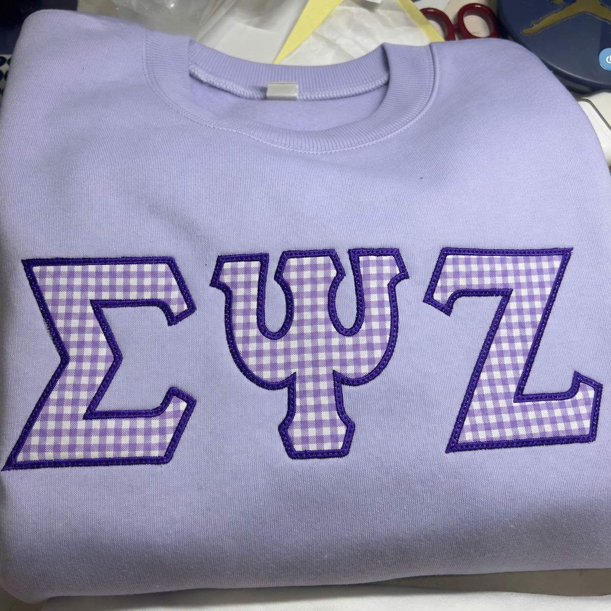 Lavender sweatshirts with custom purple gingham appliqué Greek letters